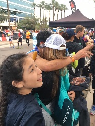NHA receives a hug from his sister after completing the race